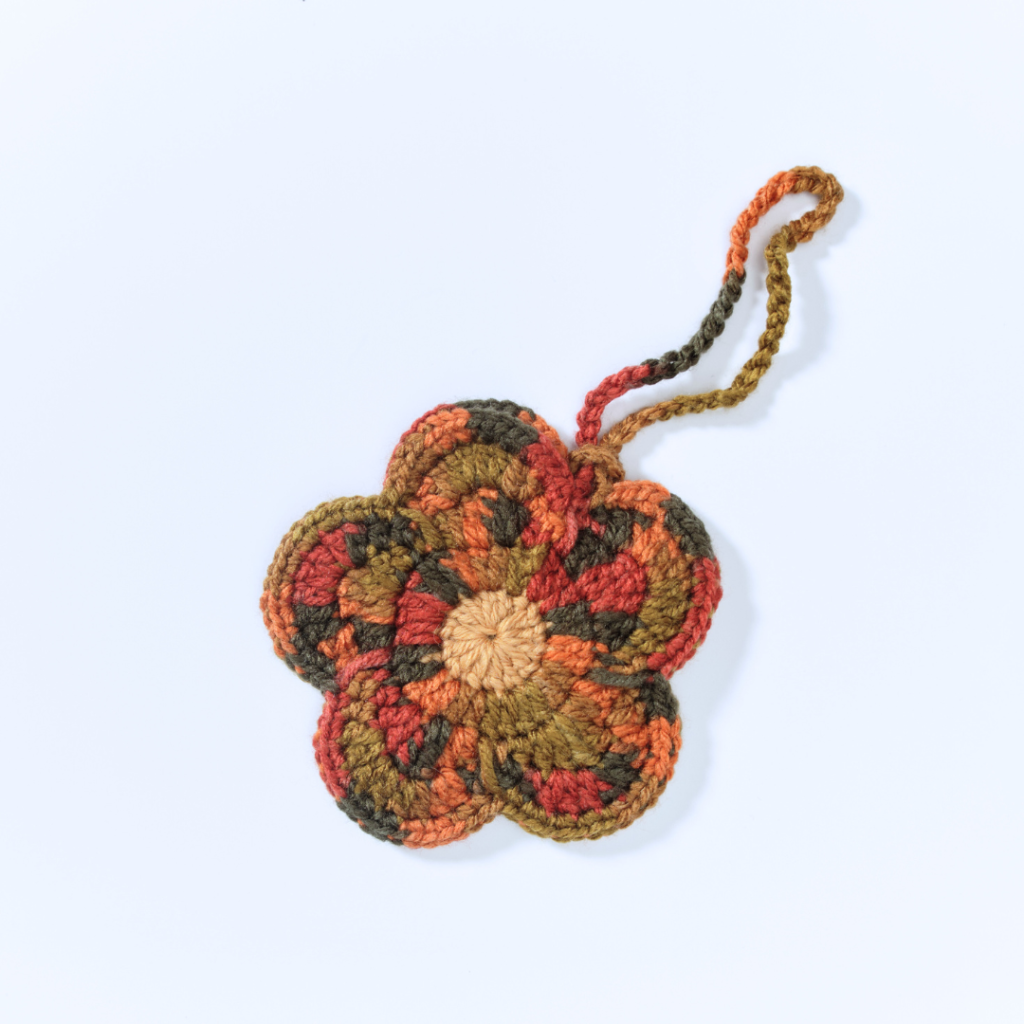 a handmade crochet floral pouch
