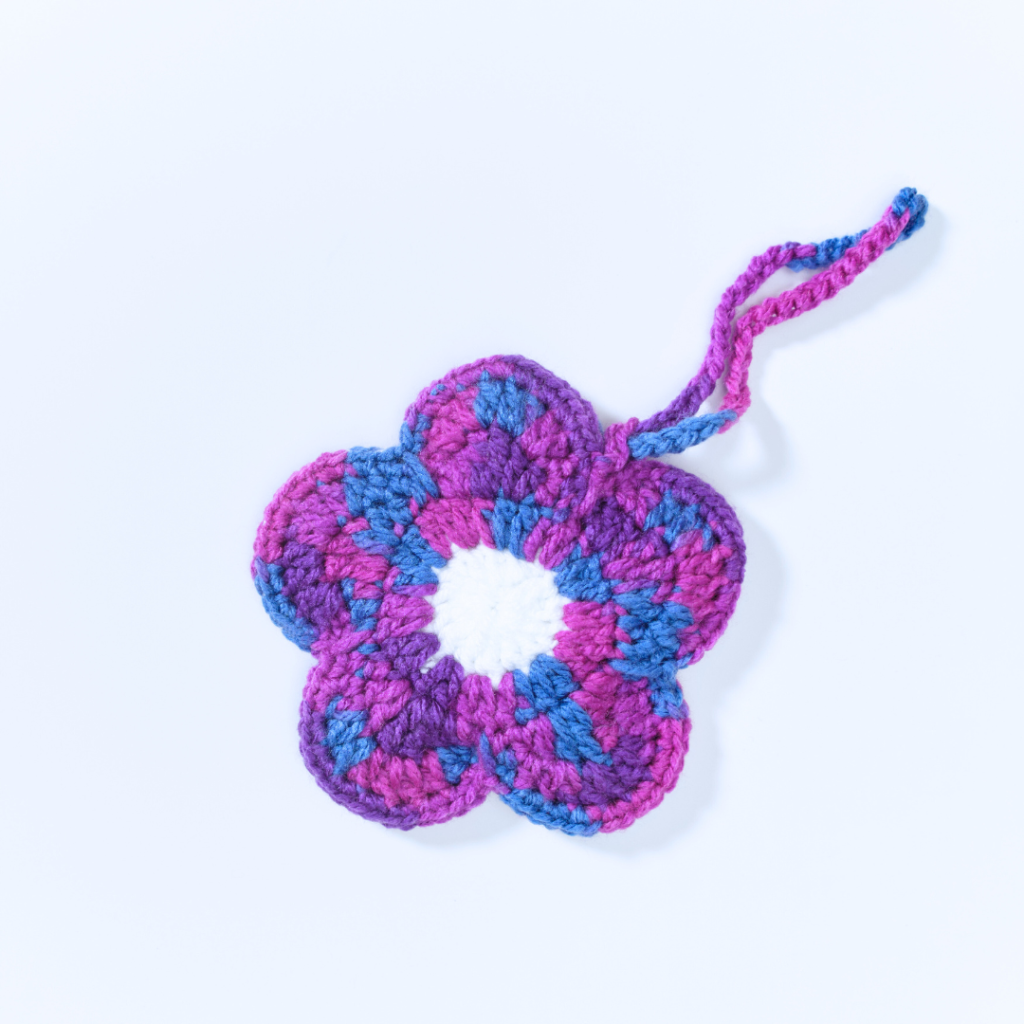 a handmade crochet floral pouch