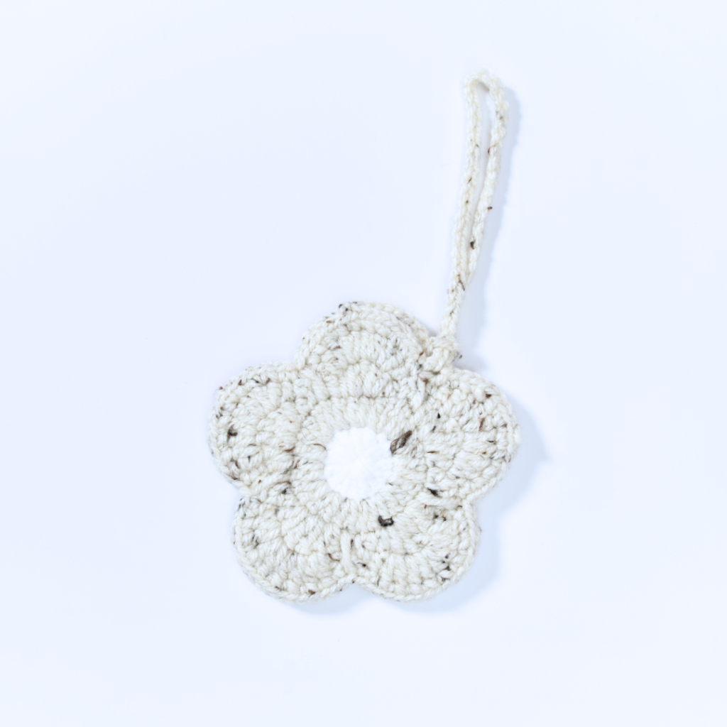 a handmade crochet floral pouch