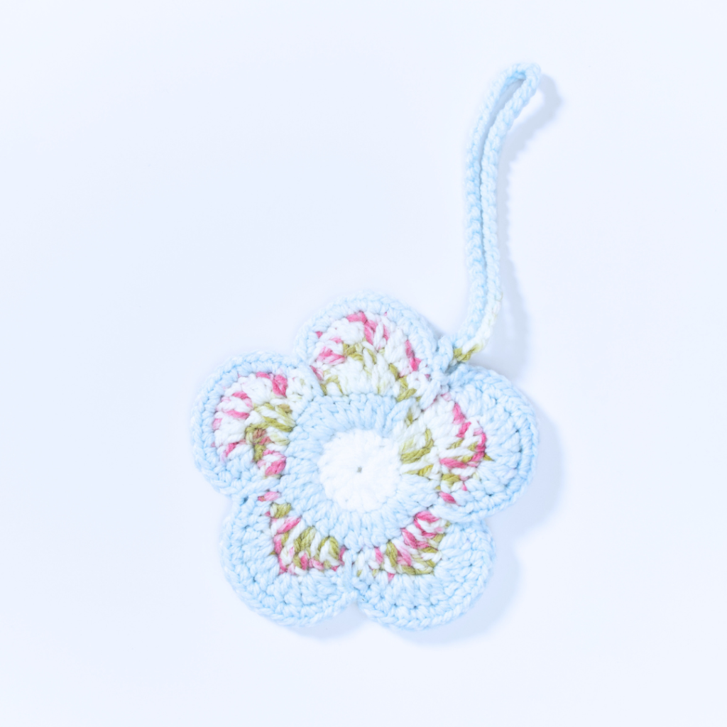 a handmade crochet floral pouch