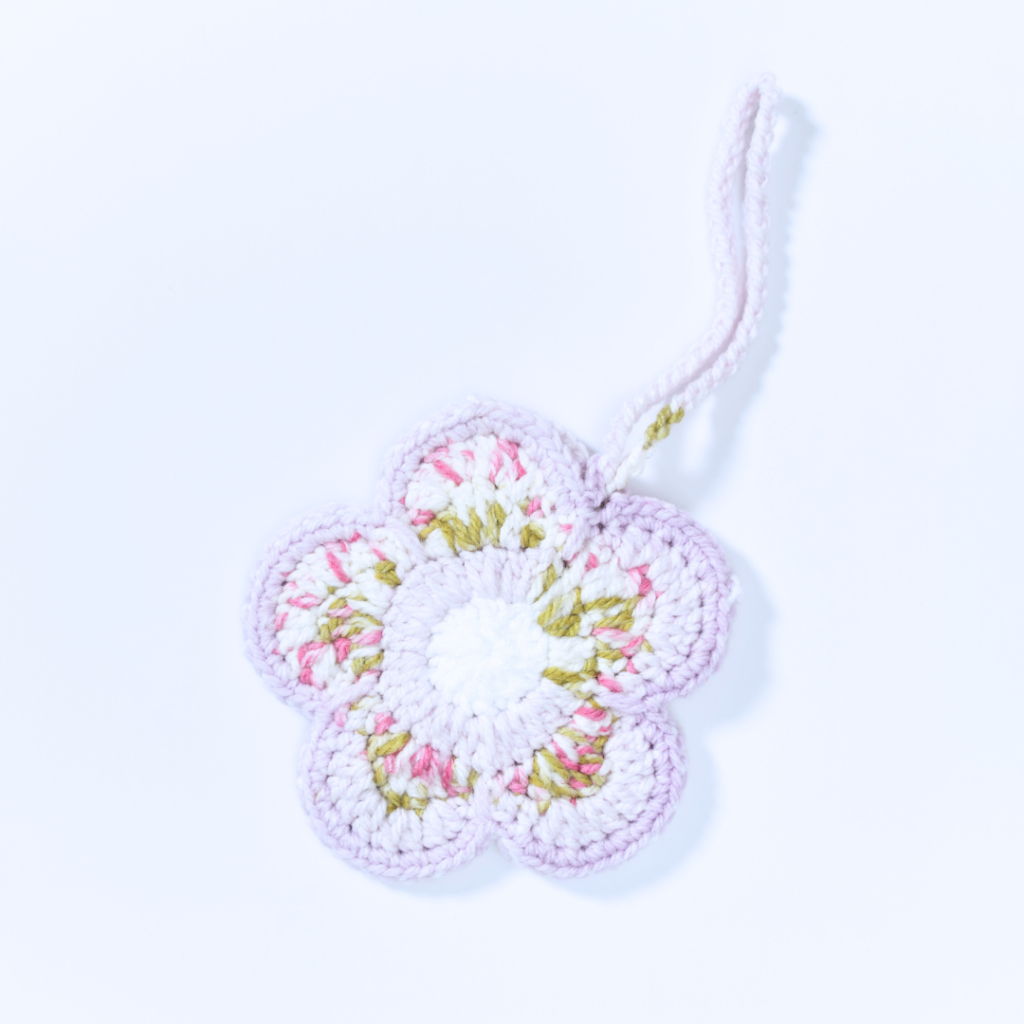 a handmade crochet floral pouch