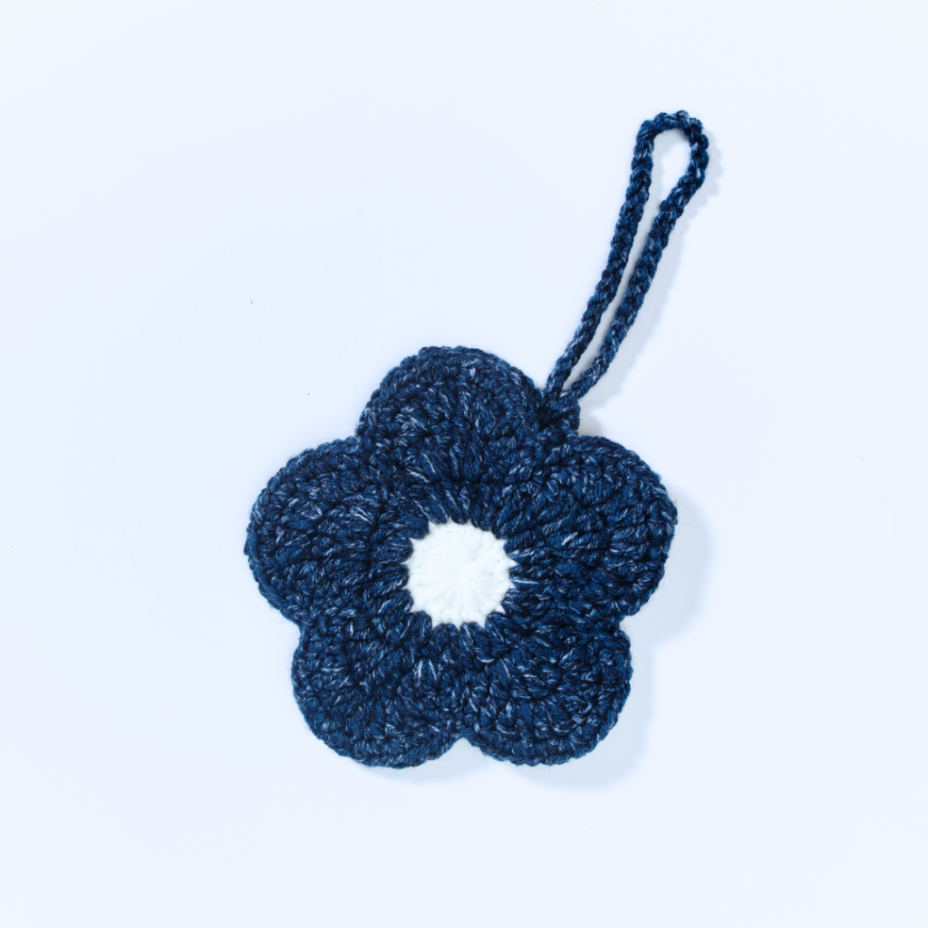 a handmade crochet floral pouch