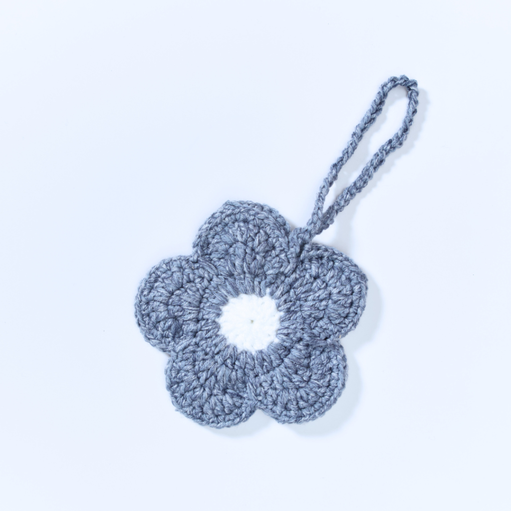 a handmade crochet floral pouch