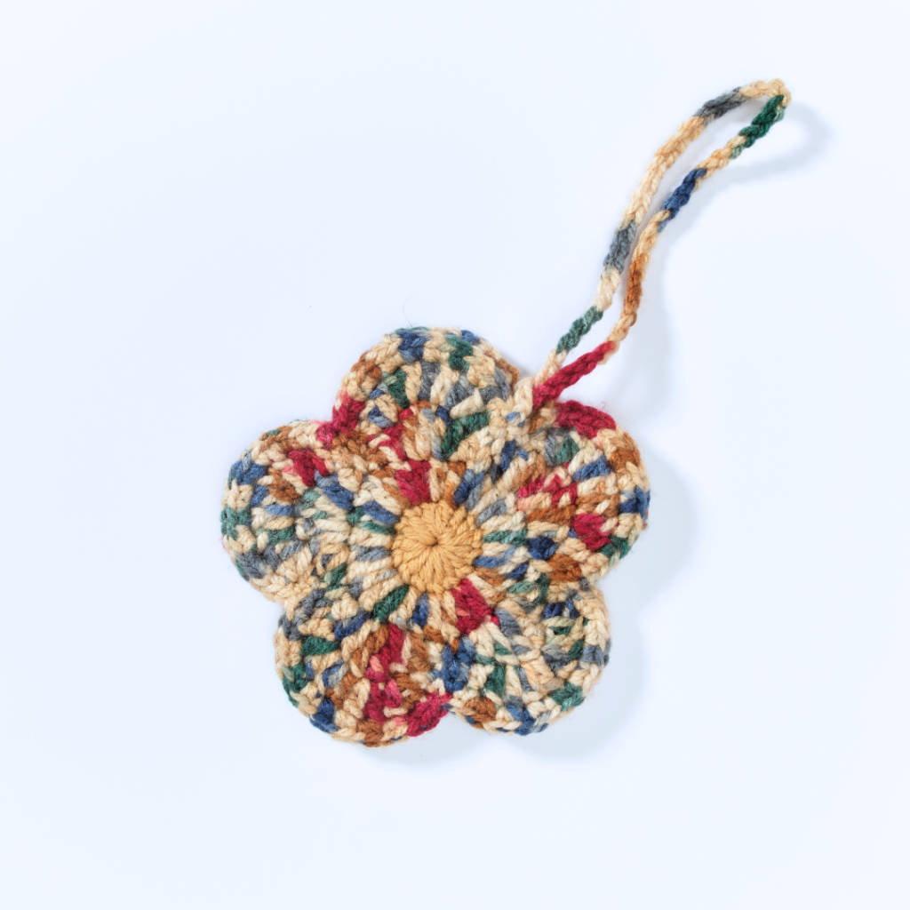 a handmade crochet floral pouch